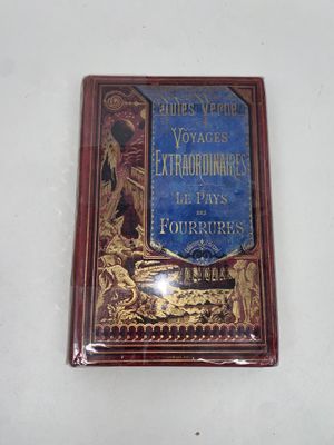an old book on a white surface with a blue cover
