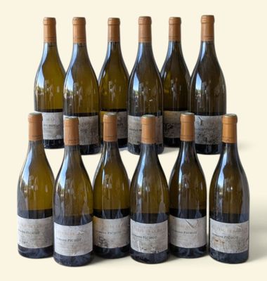 several bottles of wine are lined up on a white surface