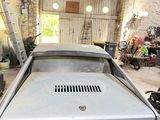 a car that is parked in a garage with other cars