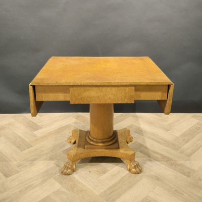 a wooden table with a small drawer on top of it
