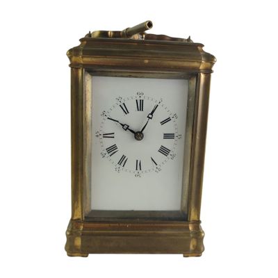 a gold clock with roman numerals on the face