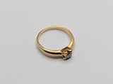 an image of a gold ring with a black diamond on it