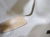 a white bag with a leather tag on it