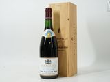 a bottle of wine in front of a wooden box