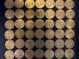 gold coins are arranged in a square pattern on a black surface