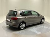 the back of a silver volkswagen b - cross parked in a white room
