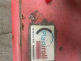a red box with a sticker on it sitting on the ground