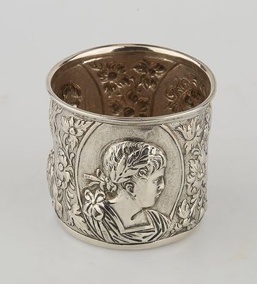 a silver cuff bracelet with an image of a woman in profile
