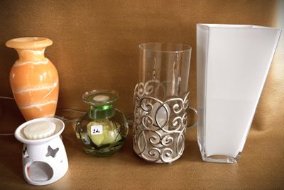 three vases and a book on a table