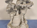 figurine of two men with guns and barrels on a blue table
