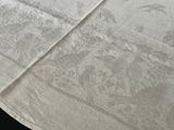 a white table cloth with a picture of birds on it