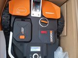 an orange and black remote control in a cardboard box