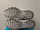 the soles of a pair of running shoes on top of a blue box