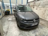 a grey vw van parked in a garage