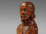un buste en bois représentant un homme barbu et moustachu