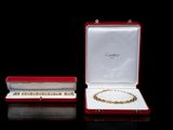 two pieces of jewelry are in a red case on a black surface