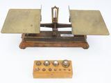 a small scale that is sitting next to a wooden block