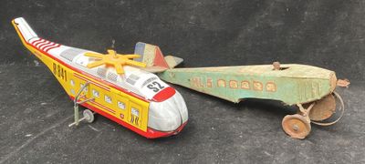 two toy airplanes sitting next to each other on a black surface