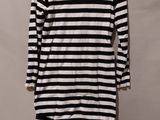 a black and white striped shirt hanging on a hanger