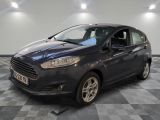 the ford fiesta is parked on a checkered floor in a showroom