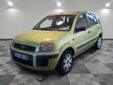 a small green car parked in a room with a checkered floor