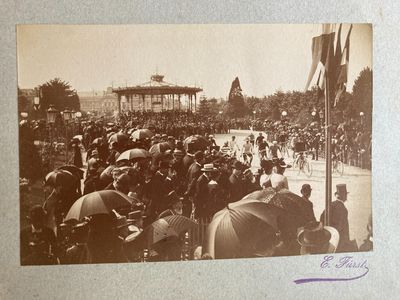 an old photo of a crowd of people with umbrellas