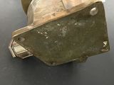 a metal object on a table with a black background