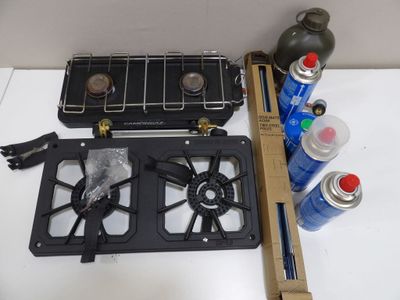 a picture of a stove top with a gas burner and a can of water