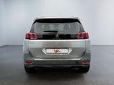 the rear view of a silver car in a white room