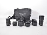 a lot of cameras and a bag on the table