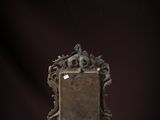 a metal frame with a picture on it on a purple surface