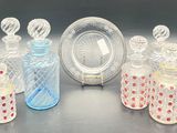 several glass bottles and a plate on a table