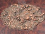 a bronze sculpture of a boar on a table