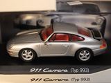 a silver toy car in a box on a table