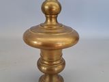 antique brass candle holder with a round top