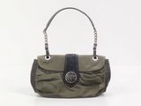 a green purse with a black handle on a white background
