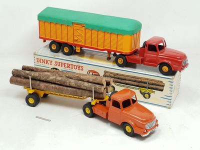 two toy trucks that are sitting next to each other