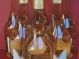 six bottles of wine are lined up on a red table