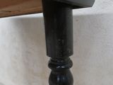 a close up of a black table with a clock on it
