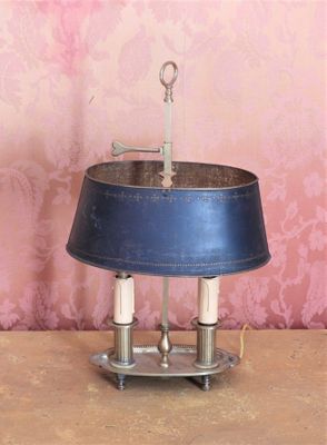 a lamp that is sitting on a table in front of a pink wall