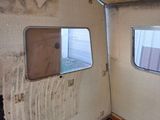 a dirty room with a window and a dirty floor