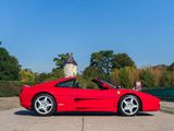 the red sports car is parked in the parking lot