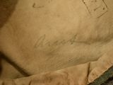 a brown bag with writing on it sitting on the floor