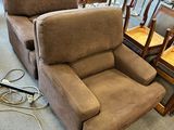 two recliners that are sitting in the middle of a room