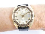 a gold wrist watch on a woman ' s wrist