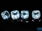 a group of three blue topazte gems sitting on top of a black surface