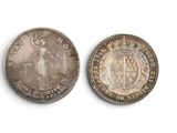 two silver coins, one of which is a woman and one of which is a man