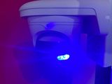 a toilet with a blue light on it in a bathroom