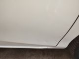 a white car with a black stripe on the side of it