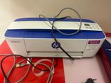 a printer sitting on top of a red and white table